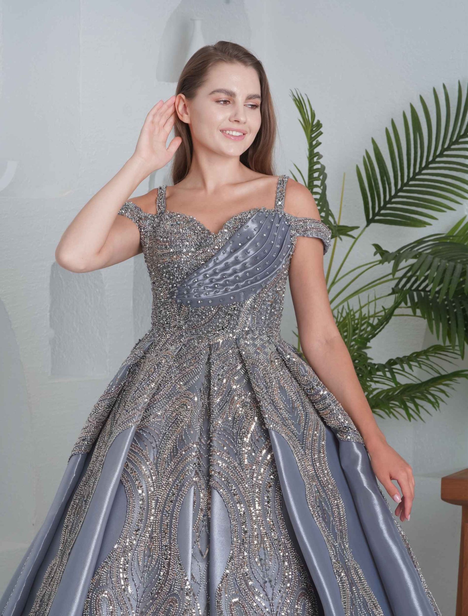 Luxurious silver ball gown with heavy embroidery and structured skirt. - Image 2