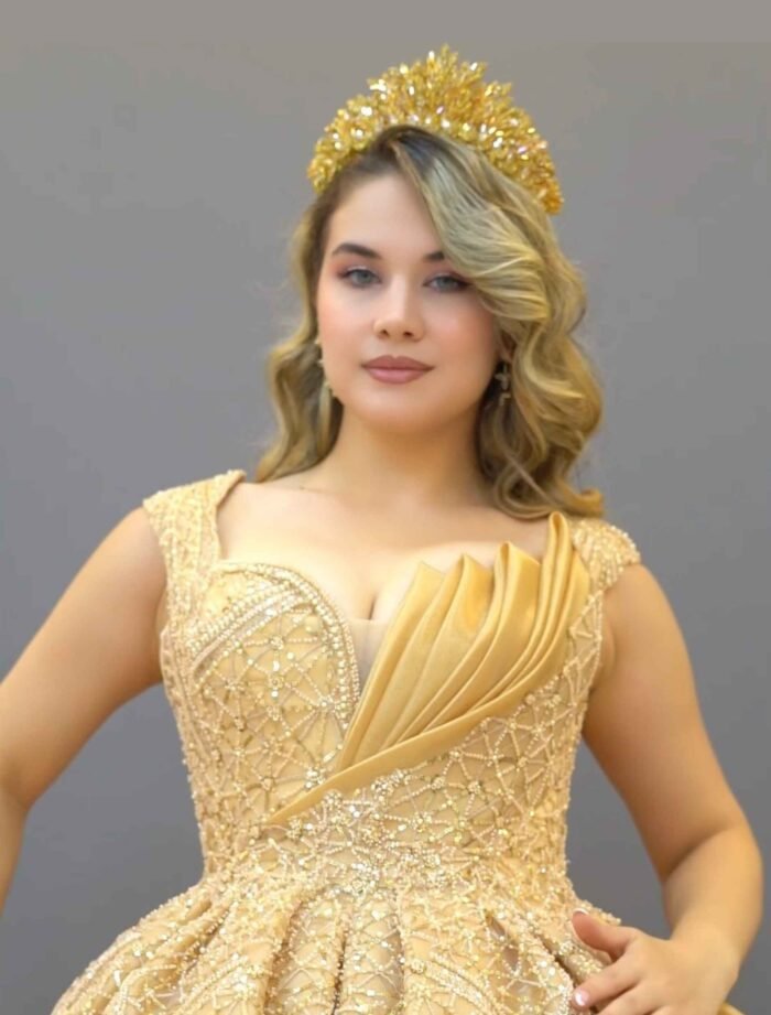 Champagne gold ball gown with off-shoulder neckline and glitter embroidery