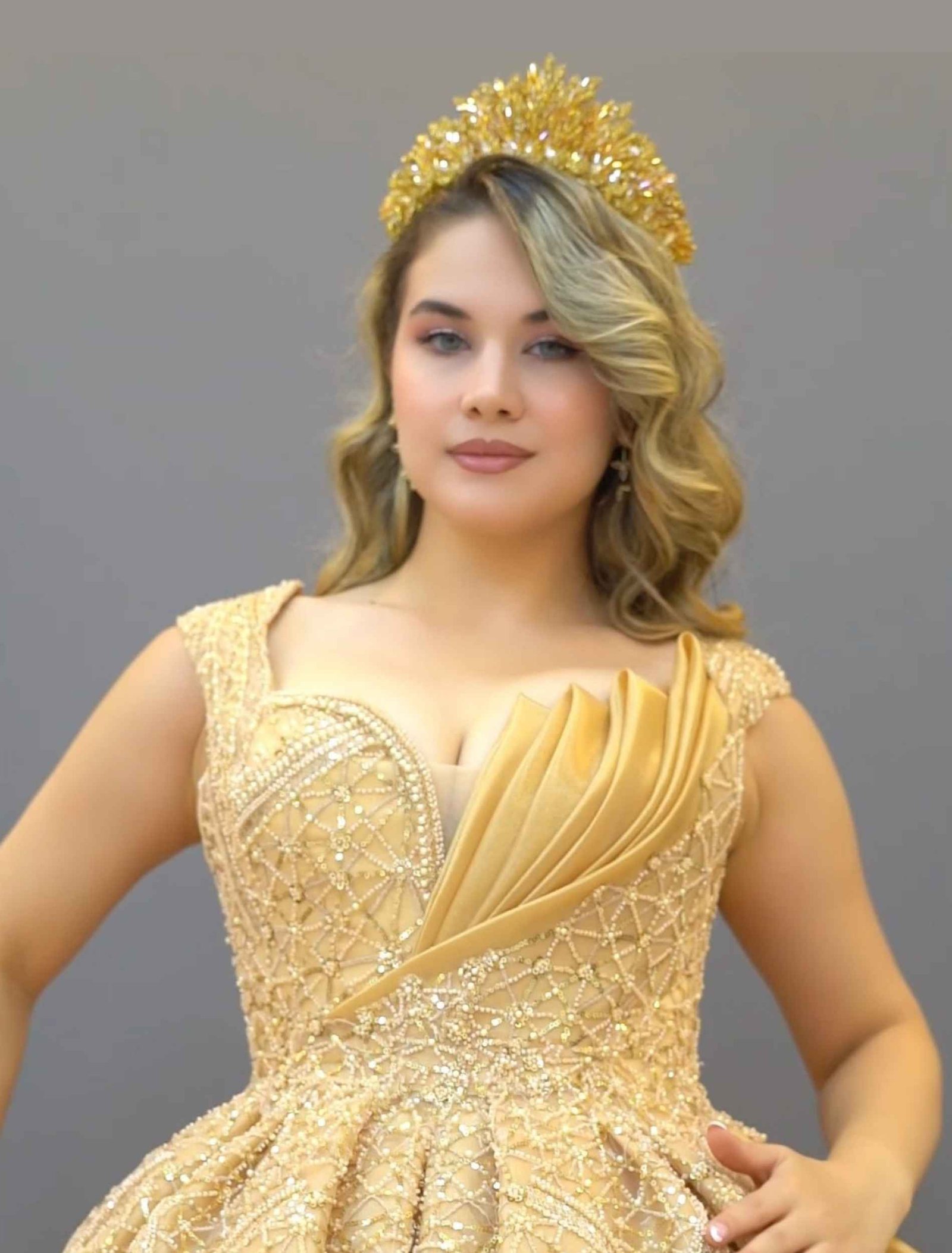 Champagne gold ball gown with off-shoulder neckline and glitter embroidery